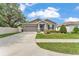 Charming home with a well-manicured lawn, complemented by stone accents and a spacious driveway at 280 Pershing St, Bartow, FL 33830