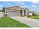 Charming home with a well-manicured lawn, complemented by stone accents and a spacious driveway at 280 Pershing St, Bartow, FL 33830