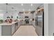 Bright kitchen featuring gray cabinets, stainless steel appliances, and center island with pendant lighting at 280 Pershing St, Bartow, FL 33830