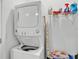 Efficient laundry area featuring a stacked washer and dryer with some storage space at 280 Pershing St, Bartow, FL 33830