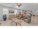Bright living room features tile flooring, neutral furniture, large windows, and an open flow to the kitchen at 280 Pershing St, Bartow, FL 33830