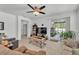 Open living room featuring neutral tones, tile flooring, access to the lanai, and a ceiling fan at 280 Pershing St, Bartow, FL 33830
