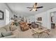Open concept living room showcasing tile floors, neutral furniture, and seamless transition to the kitchen at 280 Pershing St, Bartow, FL 33830