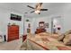 Spacious main bedroom featuring a ceiling fan, television, and coordinating dressers and furnishings at 280 Pershing St, Bartow, FL 33830