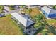 Stunning aerial view of a house with lush greenery and a brick driveway, showcasing beauty at 3016 Wood Duck Dr, Polk City, FL 33868
