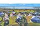 Beautiful aerial view of cozy homes with palm trees, lush green lawns, and waterfront views at 3016 Wood Duck Dr, Polk City, FL 33868