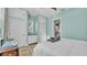 Bedroom with built-in storage, neutral carpet and walls, and a door leading to the kitchen at 3016 Wood Duck Dr, Polk City, FL 33868