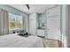 Bright bedroom with built-in storage, a large window and soothing, light-blue walls at 3016 Wood Duck Dr, Polk City, FL 33868