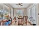 Bright dining area with a round table, hardwood floors, and lots of windows at 3016 Wood Duck Dr, Polk City, FL 33868