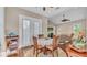 Cozy dining area with hardwood floors, natural light, and views of the living room at 3016 Wood Duck Dr, Polk City, FL 33868