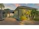 Charming home exterior with lush landscaping, brick paving, and warm lighting, perfect for relaxation at 3016 Wood Duck Dr, Polk City, FL 33868