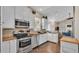 Well-equipped kitchen featuring granite countertops, stainless steel appliances, and seamless flow to living room at 3016 Wood Duck Dr, Polk City, FL 33868