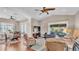 Inviting living room with vaulted ceilings, ceiling fan and seamless access to outdoor screened patio at 3016 Wood Duck Dr, Polk City, FL 33868