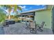 Inviting outdoor space with a patio table, chairs, awning, grill, and serene backyard view at 3016 Wood Duck Dr, Polk City, FL 33868