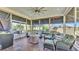 Enclosed sunroom featuring tiled floors, neutral furniture, and retractable exterior shades at 3016 Wood Duck Dr, Polk City, FL 33868