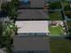 A bird's eye view of the property showcasing its layout, backyard with pergola, and surrounding neighborhood at 3873 Hampton Hills Dr, Lakeland, FL 33810