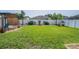 Spacious backyard features a well-maintained lawn, vinyl fence, decorative plants and a covered pergola at 3873 Hampton Hills Dr, Lakeland, FL 33810
