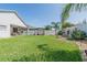 Expansive backyard features lush green lawn, modern vinyl fence, and a covered patio area with outdoor seating at 3873 Hampton Hills Dr, Lakeland, FL 33810
