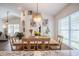 Bright dining room featuring modern decor, a unique chandelier, and natural light from the adjacent room at 3873 Hampton Hills Dr, Lakeland, FL 33810