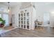 Inviting foyer with stylish décor, glass cabinet and a dedicated workspace near the front door at 3873 Hampton Hills Dr, Lakeland, FL 33810