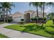 Charming single-Gathering home features a well-manicured lawn, lovely landscaping, and a two-car garage at 3873 Hampton Hills Dr, Lakeland, FL 33810