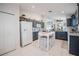 Bright kitchen features gray cabinets, granite countertops, white appliances, and a cozy dining table at 3873 Hampton Hills Dr, Lakeland, FL 33810
