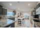 Bright kitchen with white tiled floors, granite counters, modern appliances, and large arched window at 3873 Hampton Hills Dr, Lakeland, FL 33810