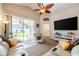 Cozy living room with modern furniture, ceiling fan, and a view of the well-maintained backyard at 3873 Hampton Hills Dr, Lakeland, FL 33810