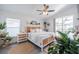 Serene main bedroom featuring neutral decor, ample natural light, and views of the landscaped backyard at 3873 Hampton Hills Dr, Lakeland, FL 33810