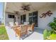 Relax on the shaded patio with comfortable seating and views of the backyard at 3873 Hampton Hills Dr, Lakeland, FL 33810