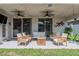 Enjoy the backyard from this covered patio with outdoor seating and fan at 3873 Hampton Hills Dr, Lakeland, FL 33810