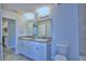 Bright bathroom features double vanity with granite countertops and modern fixtures at 4019 Tullamore Ln, Auburndale, FL 33823