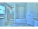 Bright bathroom boasts a glass-enclosed shower and a luxurious soaking tub, complemented by modern fixtures at 4019 Tullamore Ln, Auburndale, FL 33823