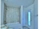 Bathroom with a tiled shower-tub combo and access to the outdoors at 4019 Tullamore Ln, Auburndale, FL 33823