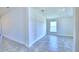 Bright bedroom with light-colored walls, tiled floors, and natural light from the window at 4019 Tullamore Ln, Auburndale, FL 33823