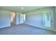 Spacious bedroom with a neutral palette, plush carpeting, and access to the backyard at 4019 Tullamore Ln, Auburndale, FL 33823