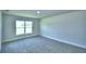 Bedroom featuring soft carpeting, a bright window view, and a calming atmosphere at 4019 Tullamore Ln, Auburndale, FL 33823