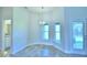 Bright dining area with stylish lighting, tile floors, and outdoor access at 4019 Tullamore Ln, Auburndale, FL 33823