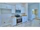 Modern kitchen with stainless steel appliances, granite countertops and white cabinetry at 4019 Tullamore Ln, Auburndale, FL 33823