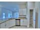 Well-lit kitchen featuring white cabinets, granite countertops, stainless steel appliances, and a spacious pantry at 4019 Tullamore Ln, Auburndale, FL 33823