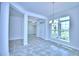 Bright open-concept living room features a stylish chandelier and abundant natural light at 4019 Tullamore Ln, Auburndale, FL 33823