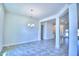 Bright, open-concept living room with tiled floors, fresh paint, and elegant chandelier at 4019 Tullamore Ln, Auburndale, FL 33823