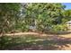 A spacious backyard with mature trees offers ample shade and privacy, creating a peaceful outdoor environment at 402 W Patterson St, Lakeland, FL 33803