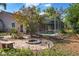 Landscaped backyard featuring a brick firepit, bench, and screened-in pool at 402 W Patterson St, Lakeland, FL 33803