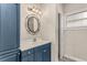 Bathroom featuring a vanity with bright blue cabinets, decorative mirror, and modern fixtures at 402 W Patterson St, Lakeland, FL 33803