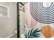 Tiled shower and bathtub with patterned curtain and accent window in the bathroom at 402 W Patterson St, Lakeland, FL 33803