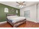 Comfortable bedroom with rustic wood accents, natural light, and wood floors at 402 W Patterson St, Lakeland, FL 33803