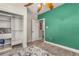Bedroom with open closet, and colorful green accent wall provides ample space for relaxing or sleeping at 402 W Patterson St, Lakeland, FL 33803