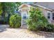 Inviting home showcasing a quaint front porch and lush greenery, offering a warm and welcoming first impression at 402 W Patterson St, Lakeland, FL 33803