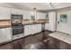 Well-lit kitchen with white cabinets, stainless steel appliances, and easy-to-clean tile flooring at 402 W Patterson St, Lakeland, FL 33803